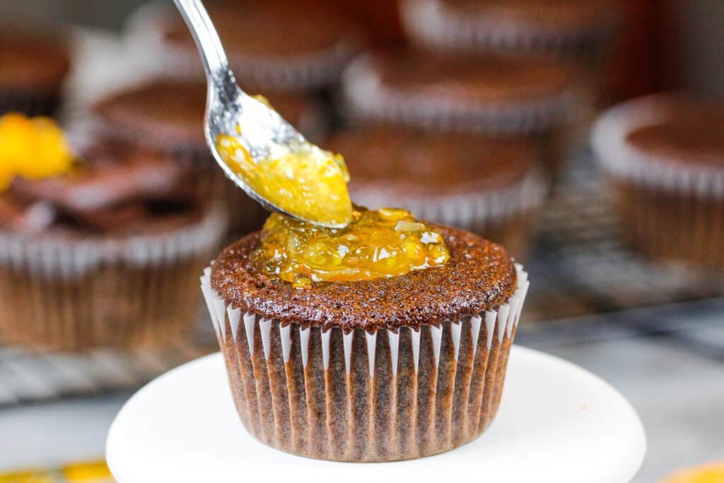 image of chocolate cupcakes being filled with orange marmalade