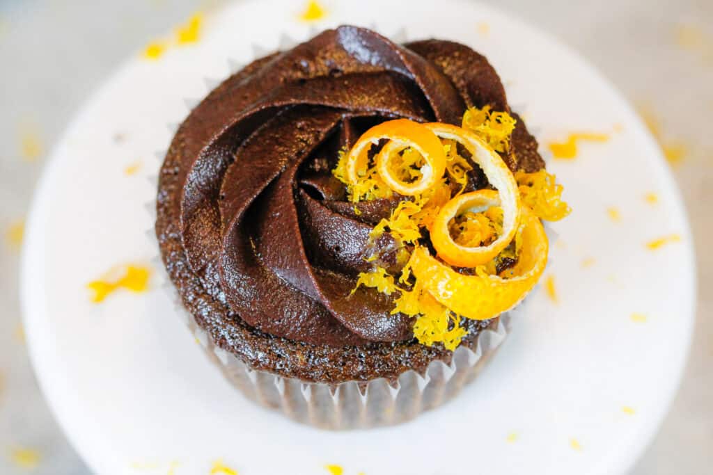 image of a chocolate orange cupcake decorated with a sprinkle of fresh orange zest