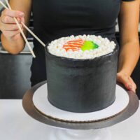 image of a sushi roll cake made with fluffy vanilla cake layers