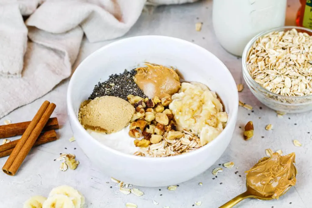 image of ingredients in a bowl ready to make a batch of banana overnight oats shared as part of a banana recipe round up