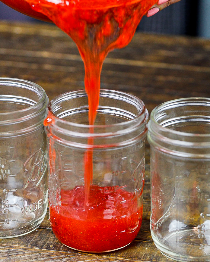 image of certo freezer jam being poured into a wide mouthed mason jar