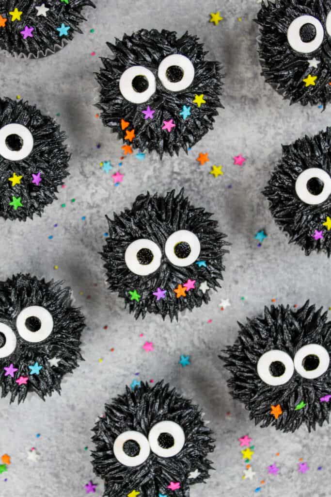 image of soot sprite cupcakes made with black cocoa frosting and candy sprinkle eyes