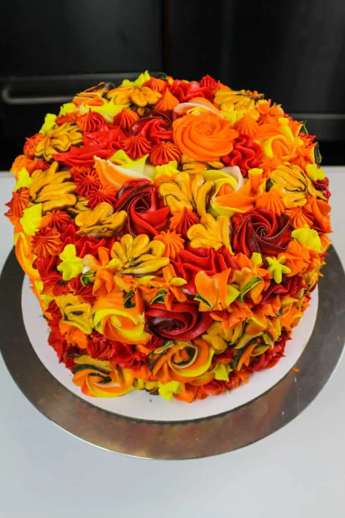 image of a beautiful apple pie layer cake frosting with colorful cinnamon buttercream