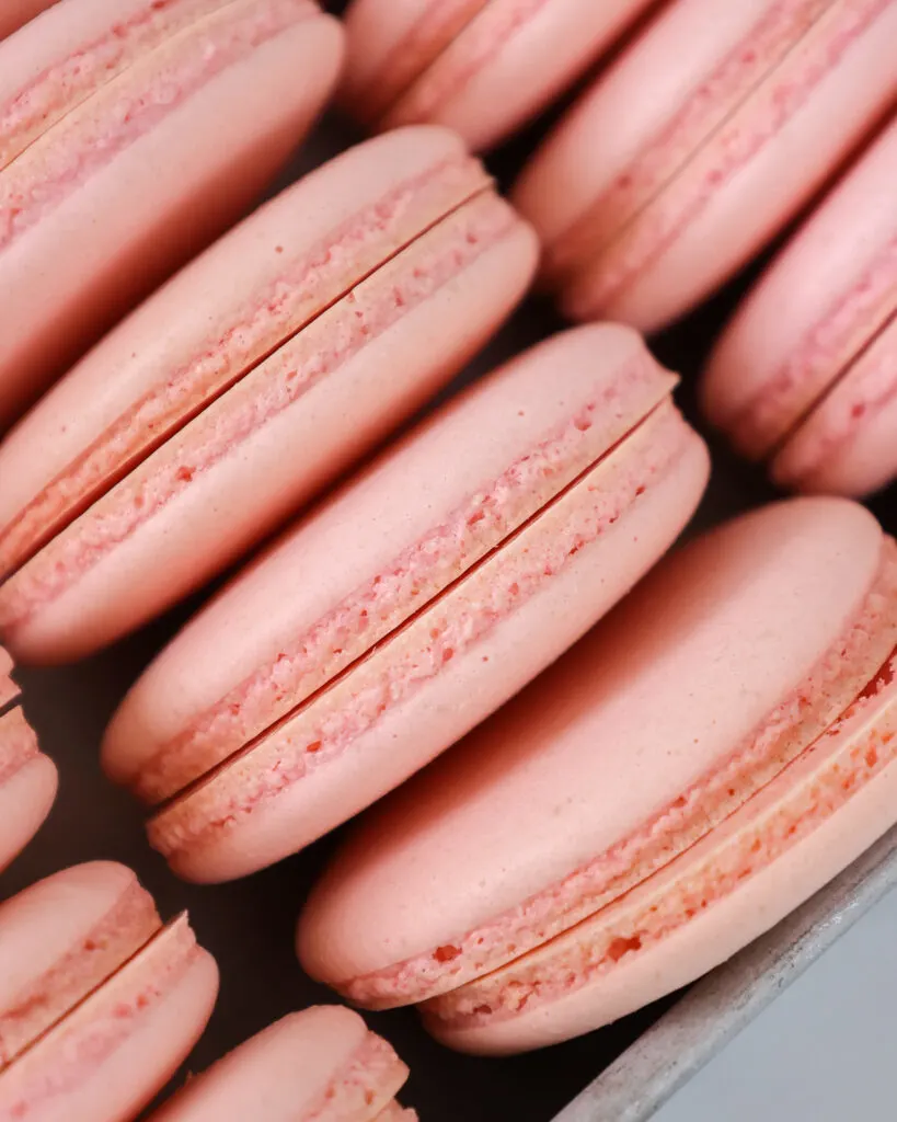 image of pink macaron Italian shells that have been baked and have perfect feet