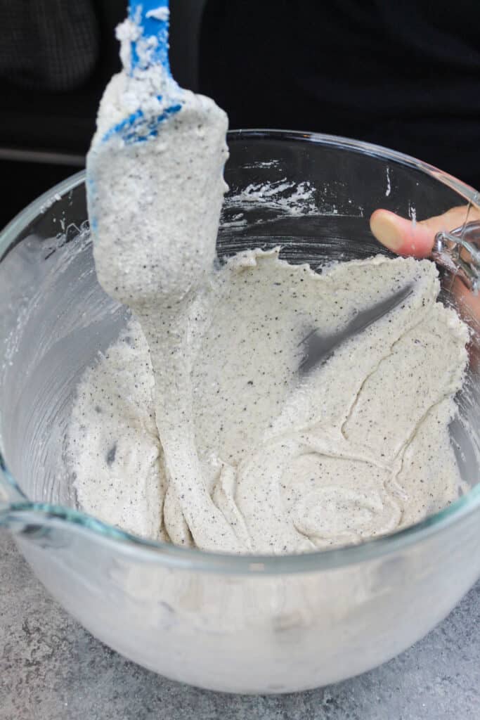 image of oreo macaron batter that's been mixed perfectly to have a thick lava or ribbon like consistency
