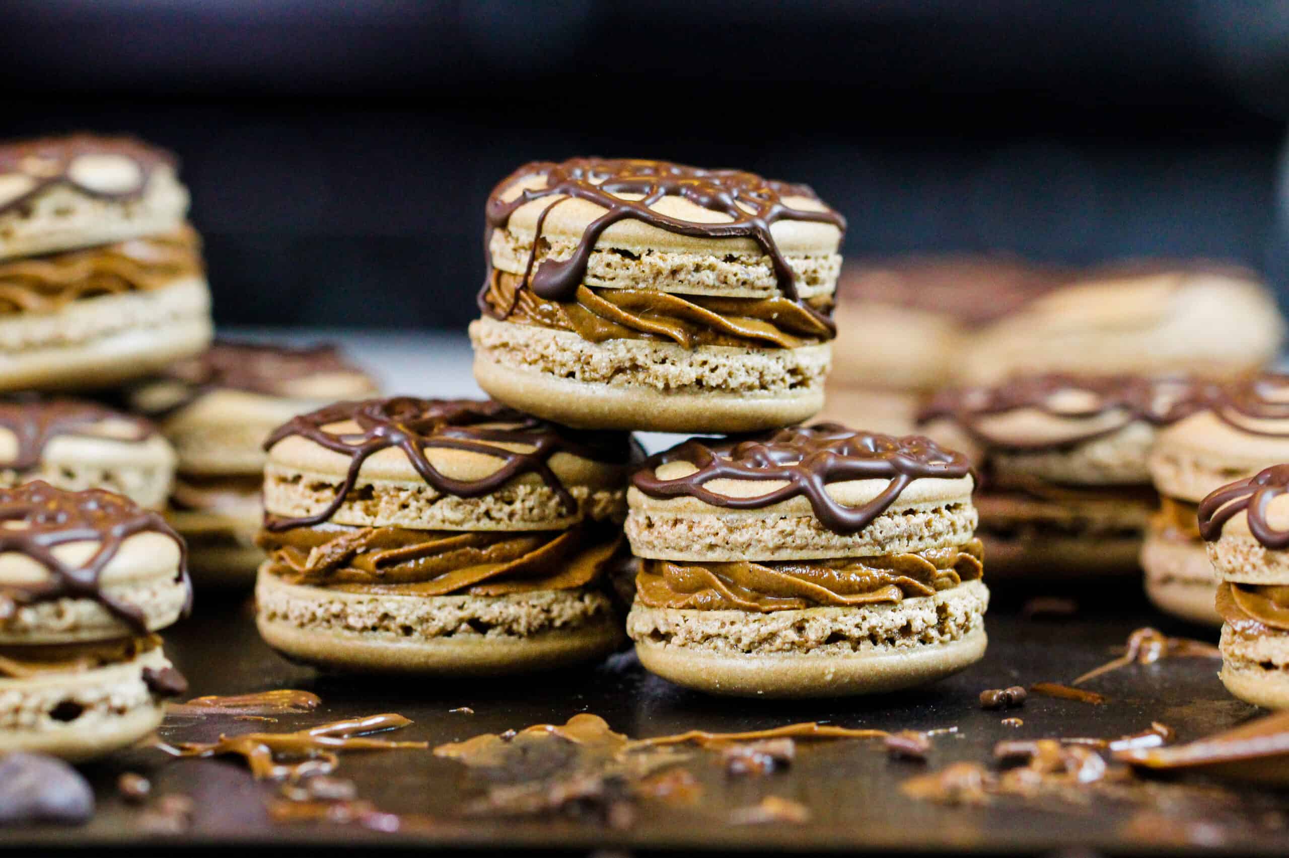 image of Nutella macarons that have been decorated with drizzled chocolate