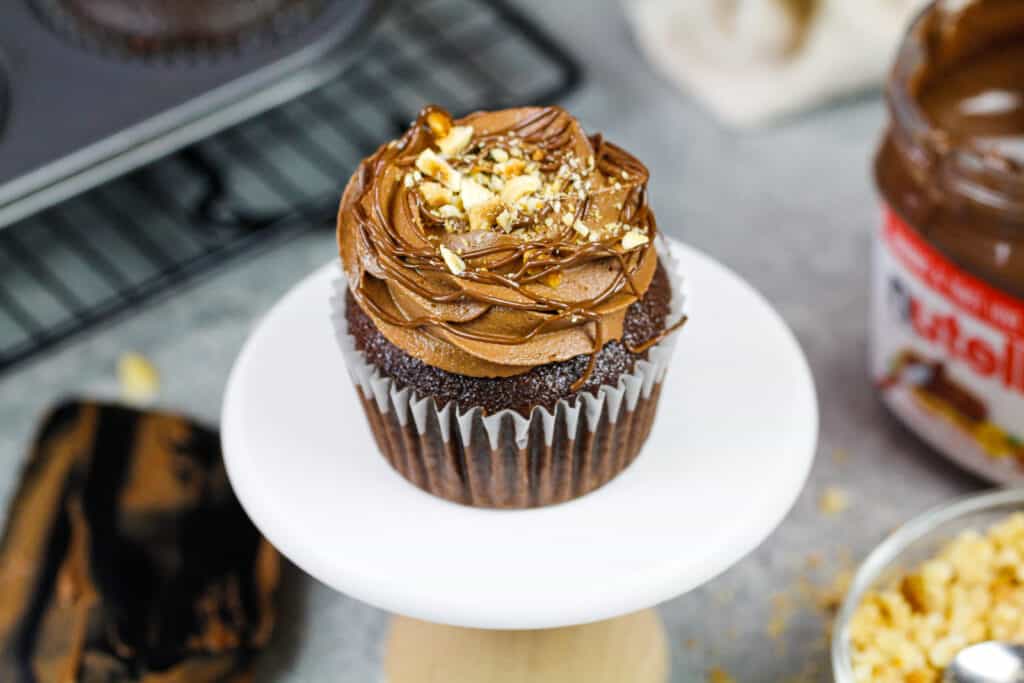 image of a pretty chocolate nutella cupcake decorated and placed on a cute little cupcake stand