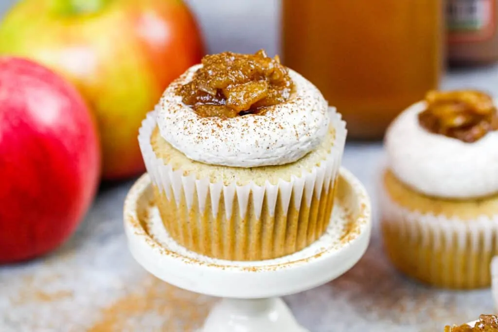 image of an apple cider cupcake on a cupcake stand after being decorated