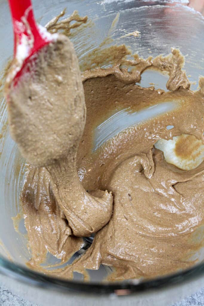 image of chocolate macaron batter that's ready to be piped