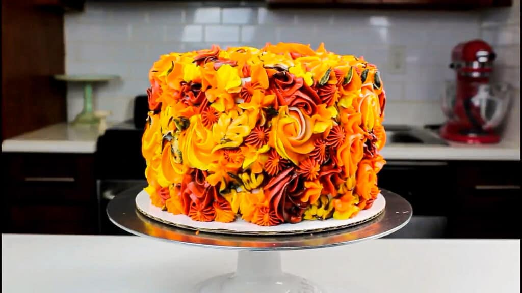 image of an apple pie layer cake that's been decorated with pretty Fall buttercream