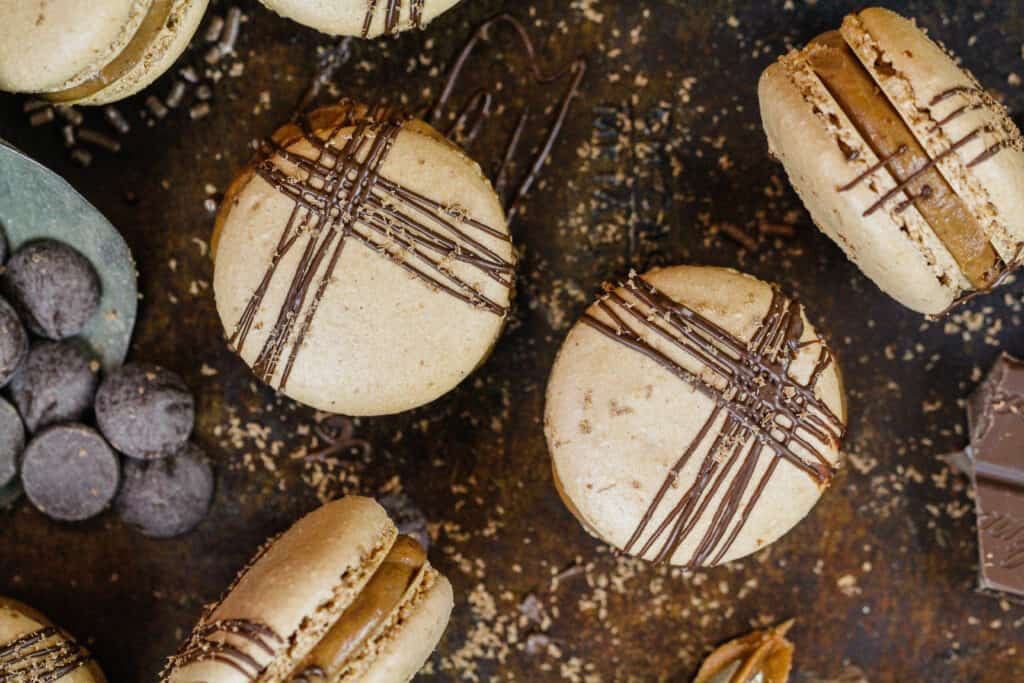 image of french chocolate macarons decorated with a beautiful drizzle of melted chocolate