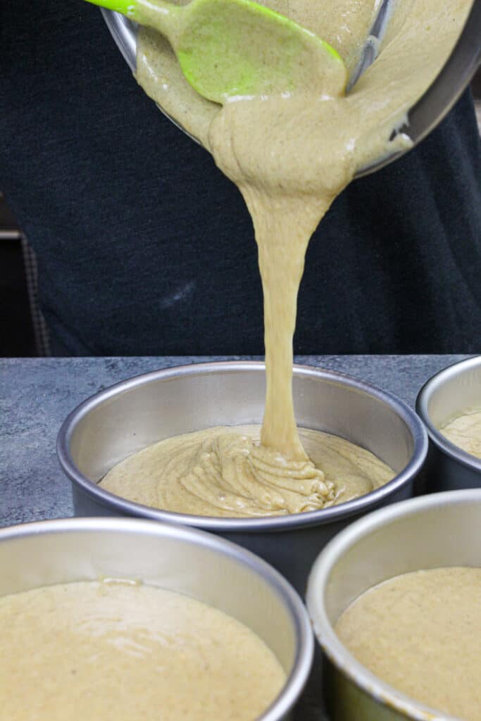 image of spice cake batter being poured into a greased cake pan