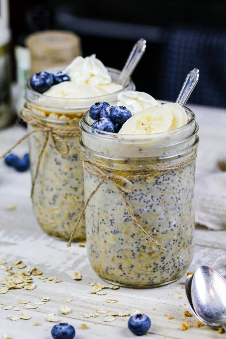 image of maple overnight oats made in cute mason jars and topped with fresh fruit