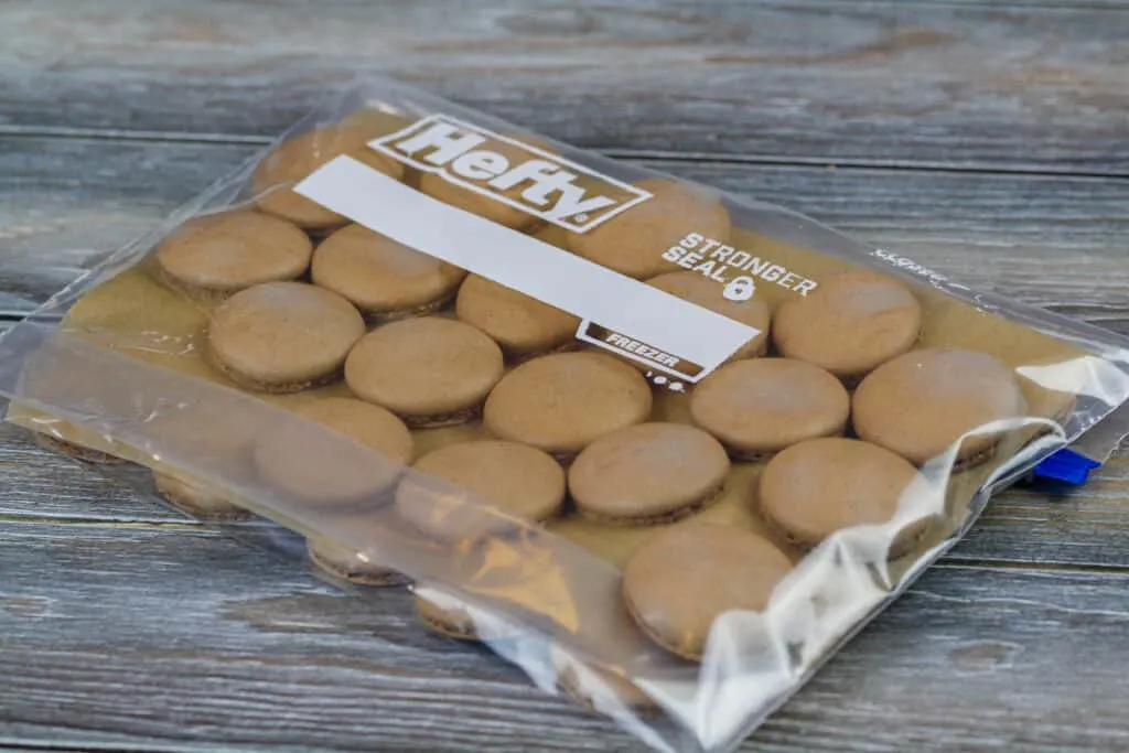 image of chocolate macaron shells that have been made in advance and frozen in a freezer bag to keep them fresh.