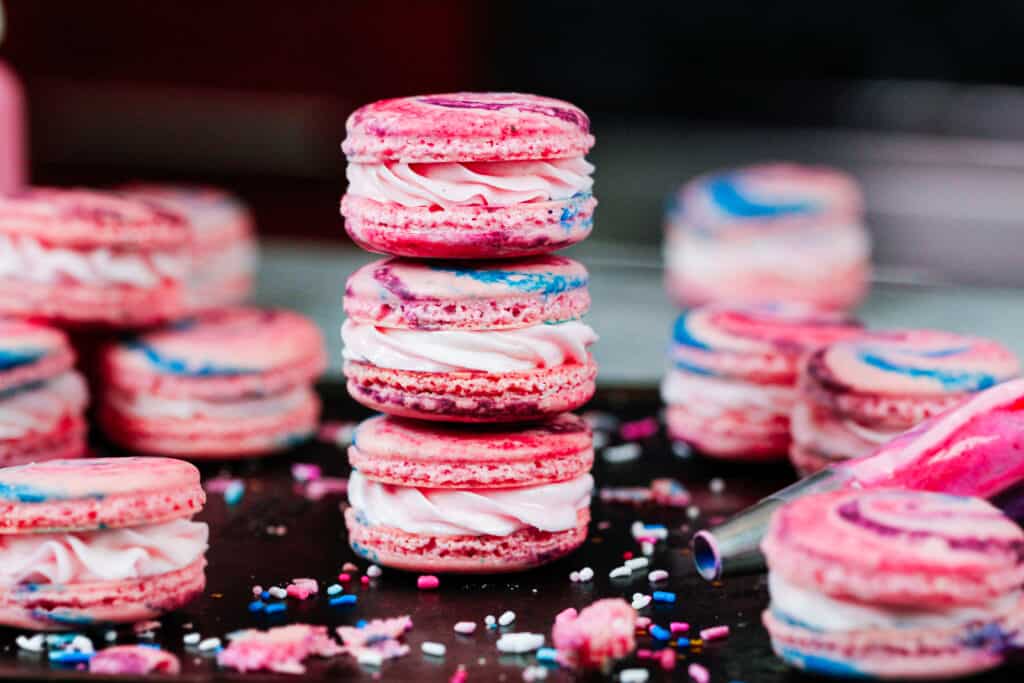 image of cotton candy macarons stacked on top of each other