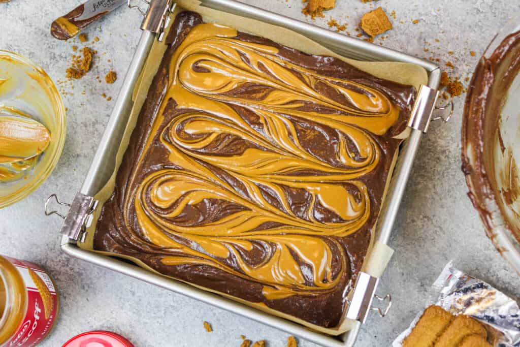 image of biscoff brownies that have been swirled with cookie butter and are ready to be baked