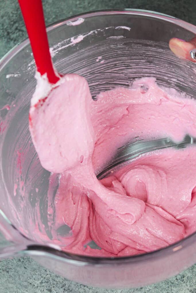 image of pink french macaron batter being mixed to make cotton candy macarons