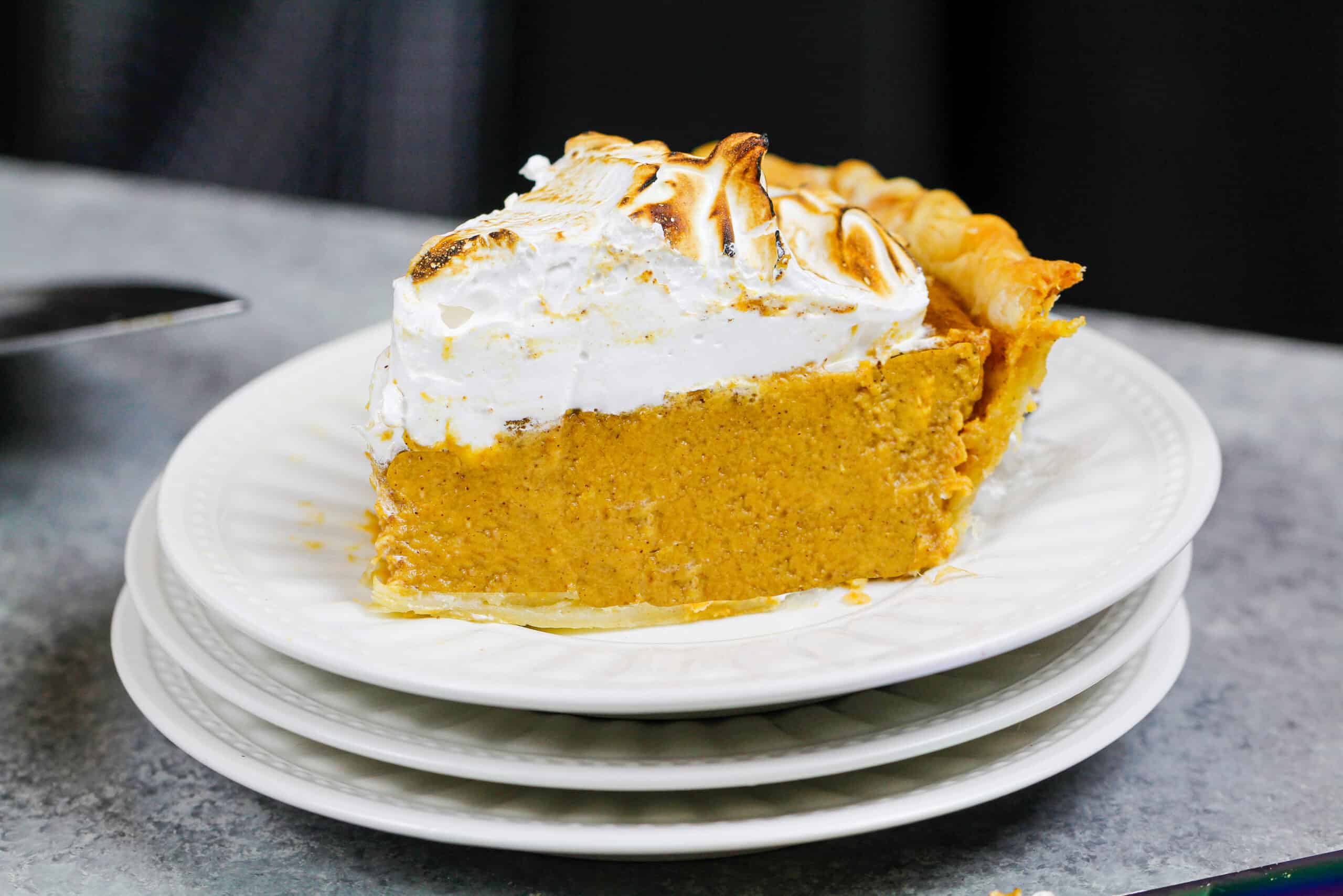 image of a slice of mascarpone pumpkin pie topped with toasted meringue