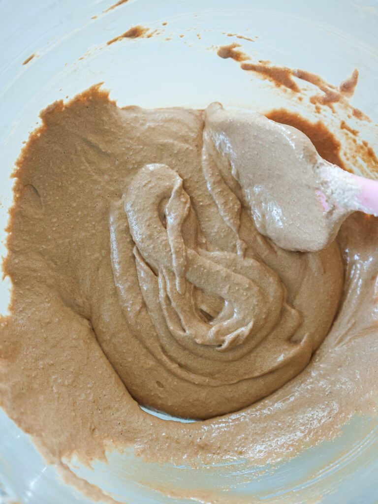 image of chocolate macaron batter that's been mixed properly and passes the figure 8 test