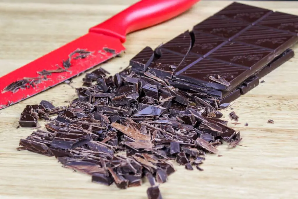 image of high quality dark chocolate that's been chopped finely being being melted down and tempered