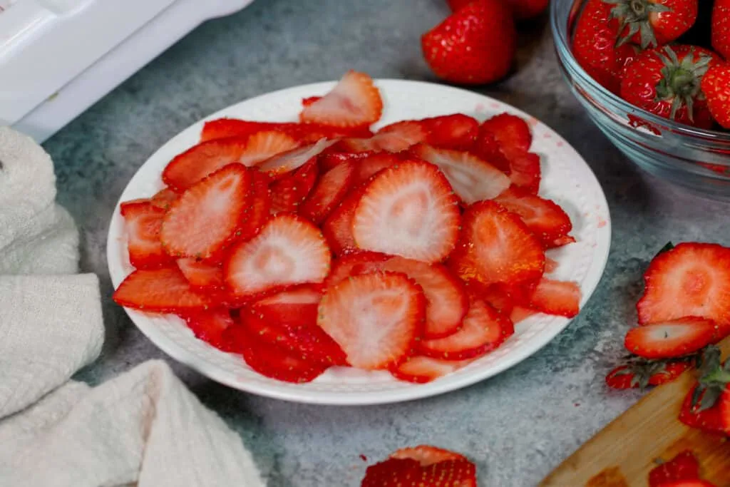 image of thinly sliced strawberries on a plate
