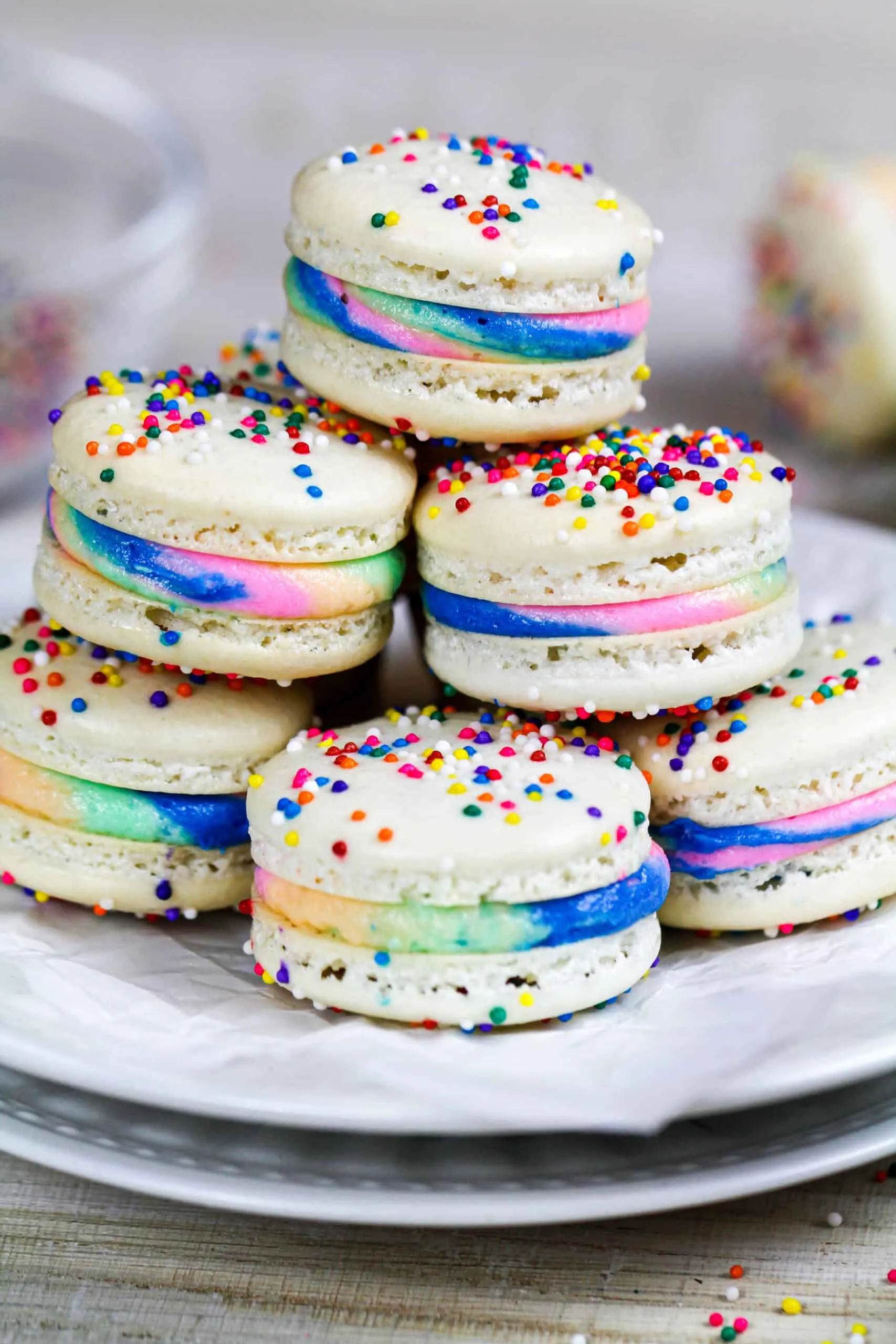 image of rainbow macarons stacked on a plate