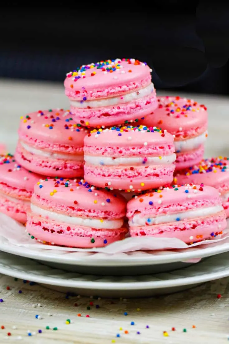image of birthday cake macarons stacked on a plate