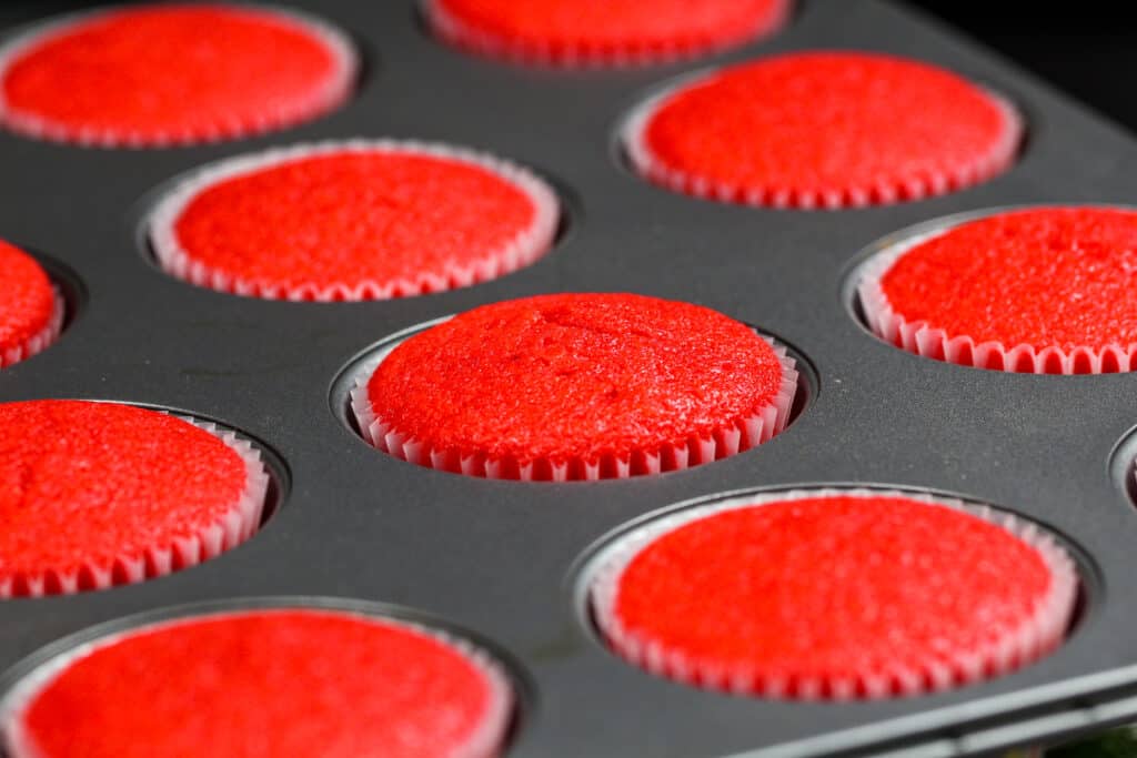 image of a pan of red cupcakes that have been baked and are cooling in the pan