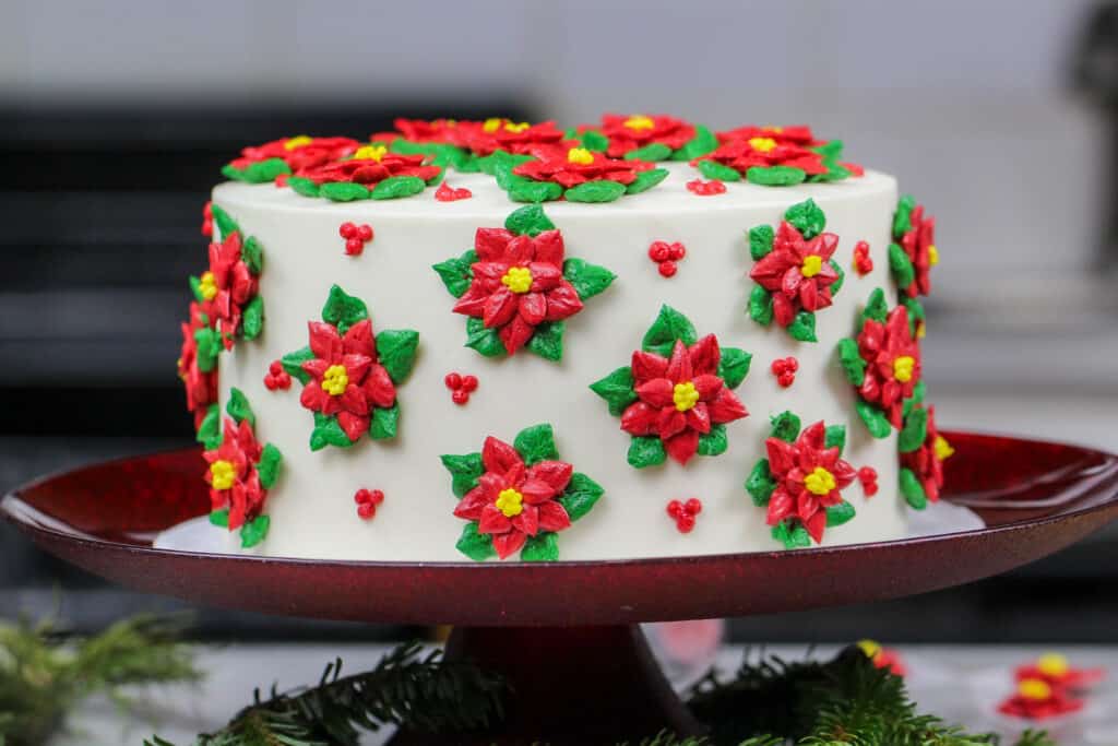 image of poinsettia cake made with red and green buttercream