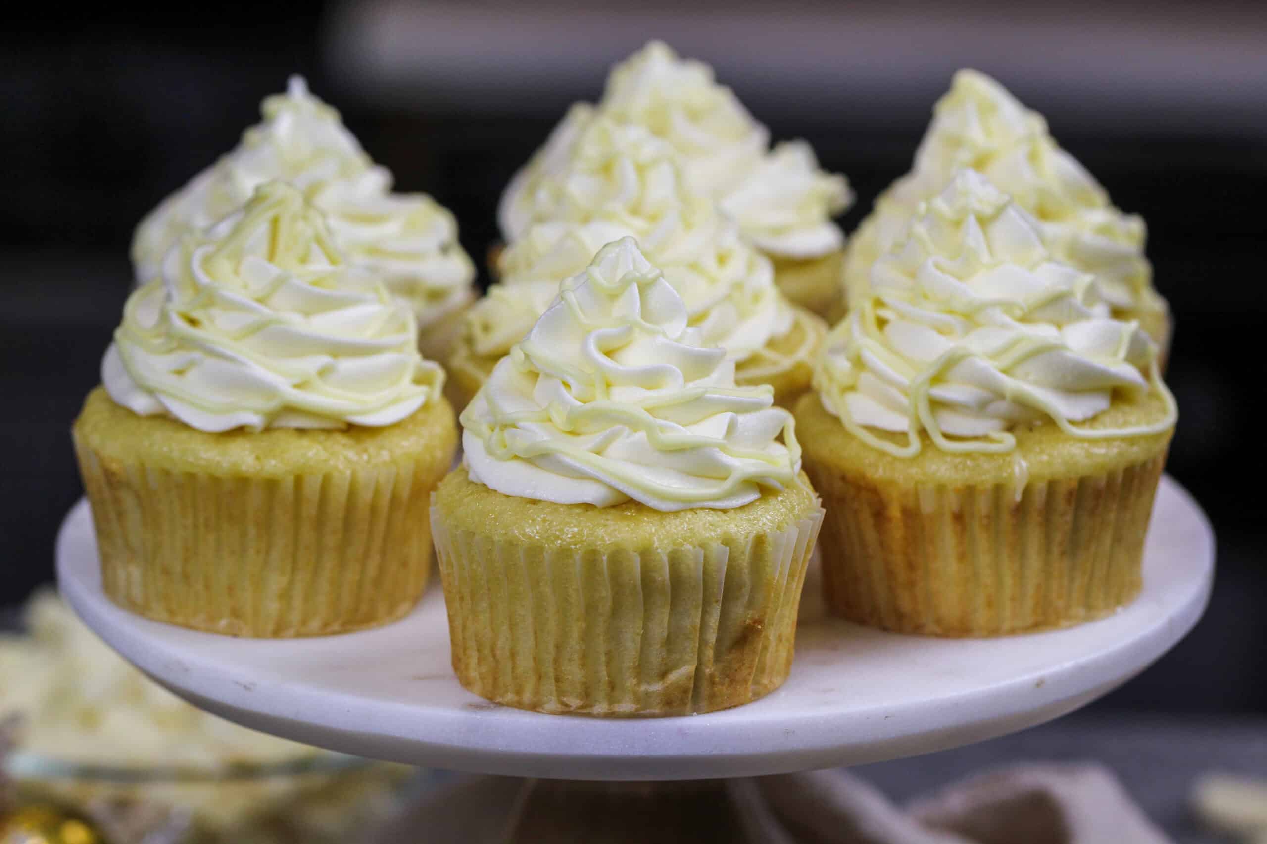 image of white chocolate cupcakes that have been filled with white chocolate ganache and frosted with a fluffy white chocolate buttercream