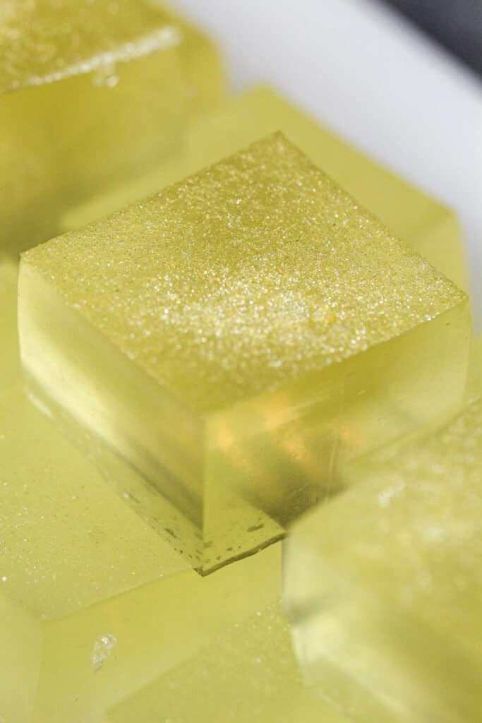 image of a beautiful nye-themed champagne jello shot that's been dusted with edible gold glitter