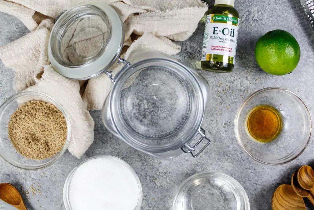 image of ingredients laid out to coconut lime sugar scrub made in a reusable glass jar to be used as a natural exfoliator