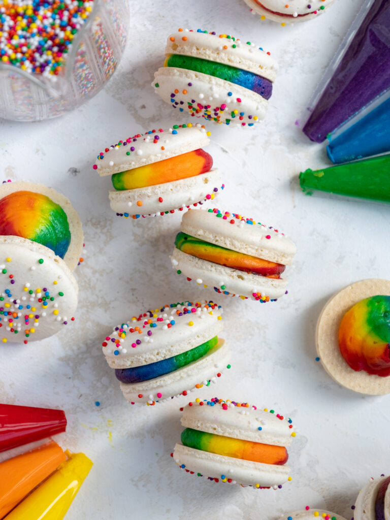 image of rainbow macarons that have been filled with colorful buttercream