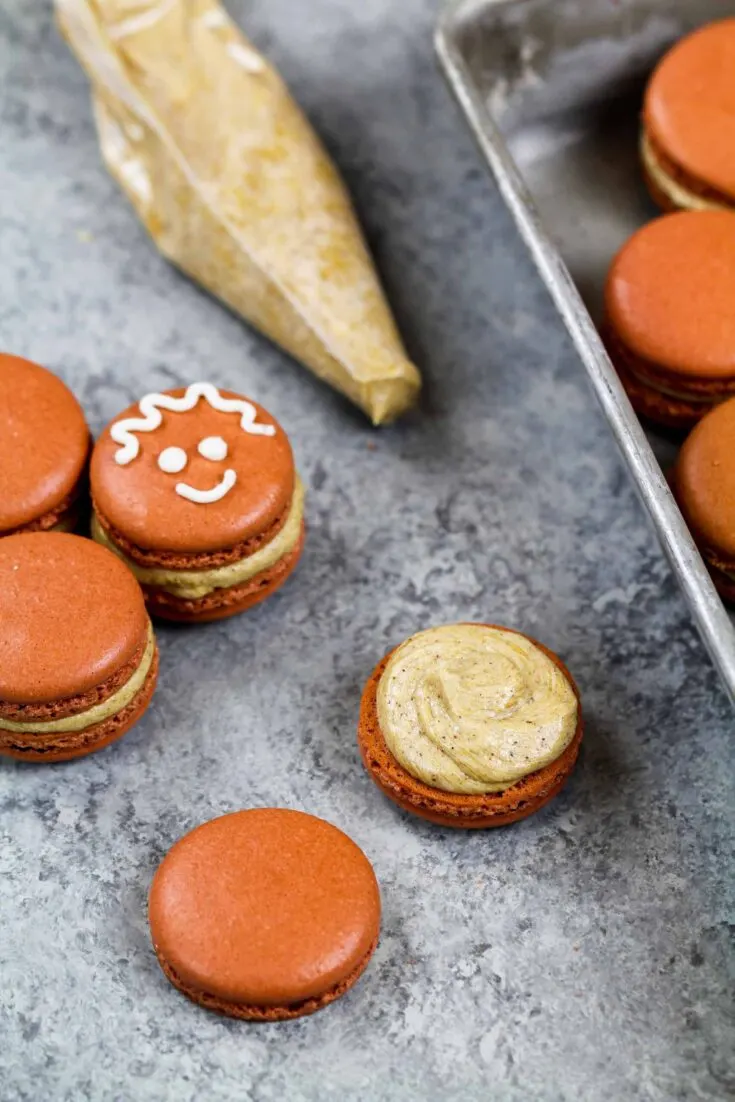 image of a gingerbread macaron frosted with gingerbread buttercream frosting