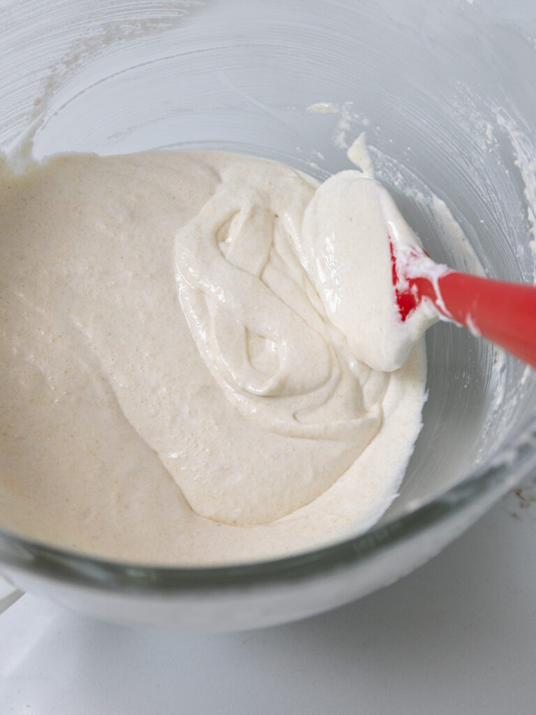 image of white French macaron batter that's been mixed the perfect amount and has been used to make two figure 8's 