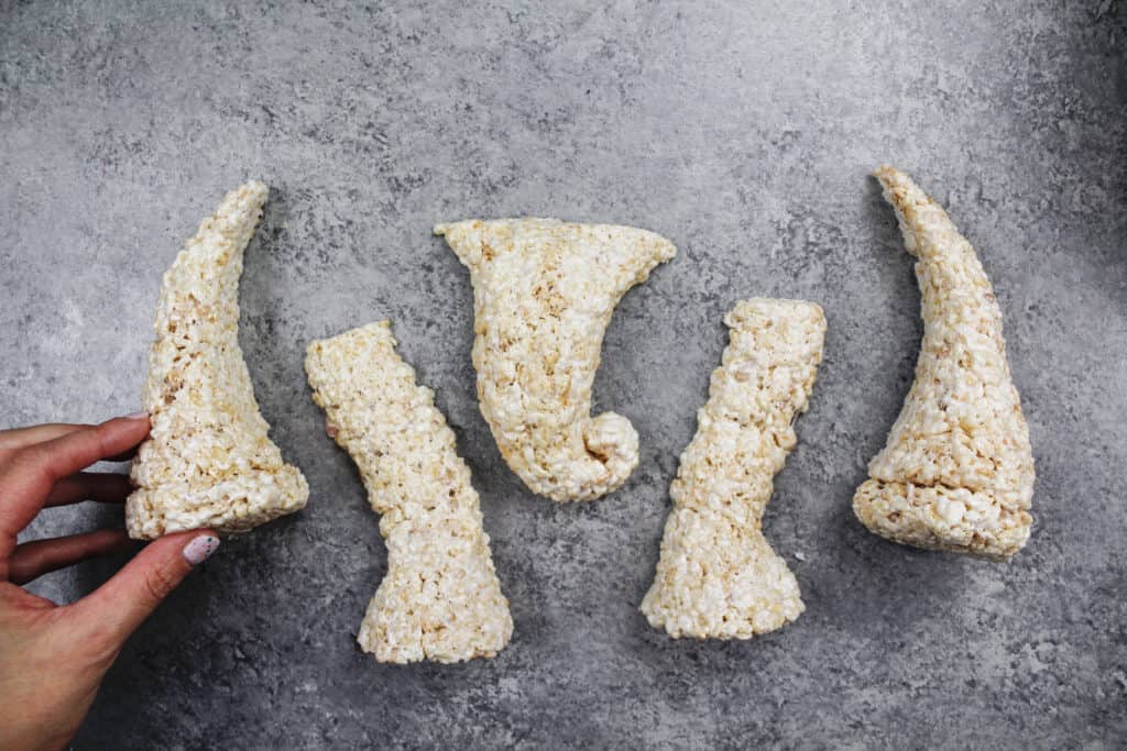 image of cake decorating friendly rice krispie treats shaped into legs and a trunk to make an elephant cake