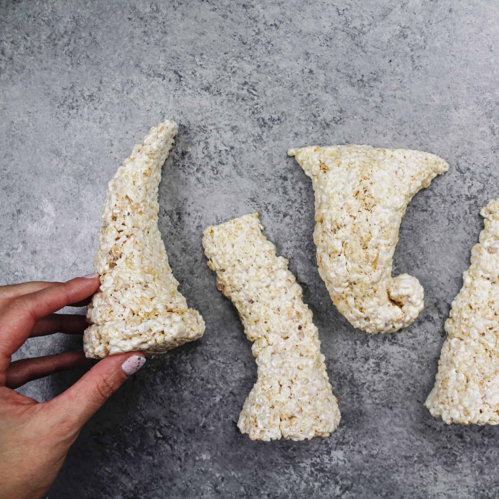 image of cake decorating friendly rice krispie treats shaped into legs and a trunk to make an elephant cake