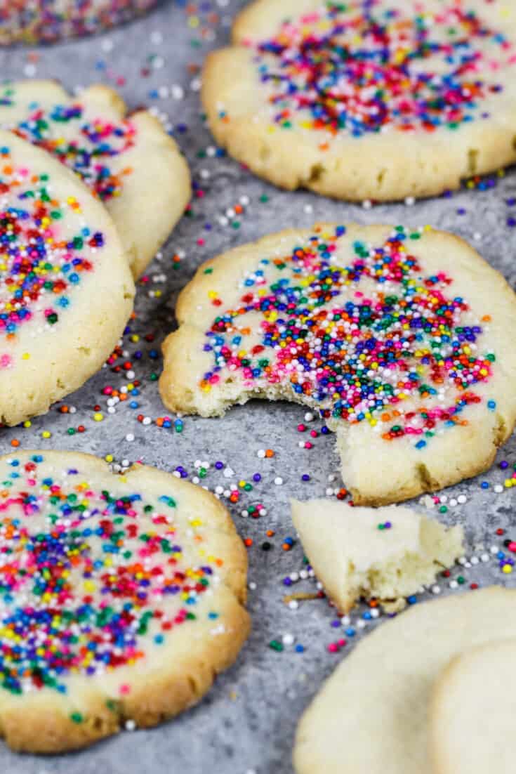 image of cream cheese shortbread cookies topped with nonpareil sprinkles