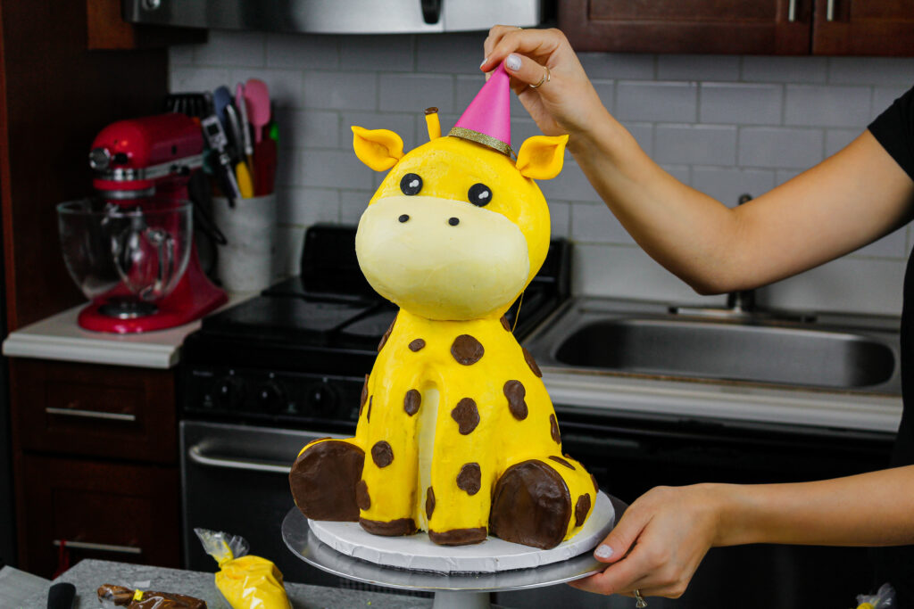 image of a giraffe cake made with buttercream and rice krispies