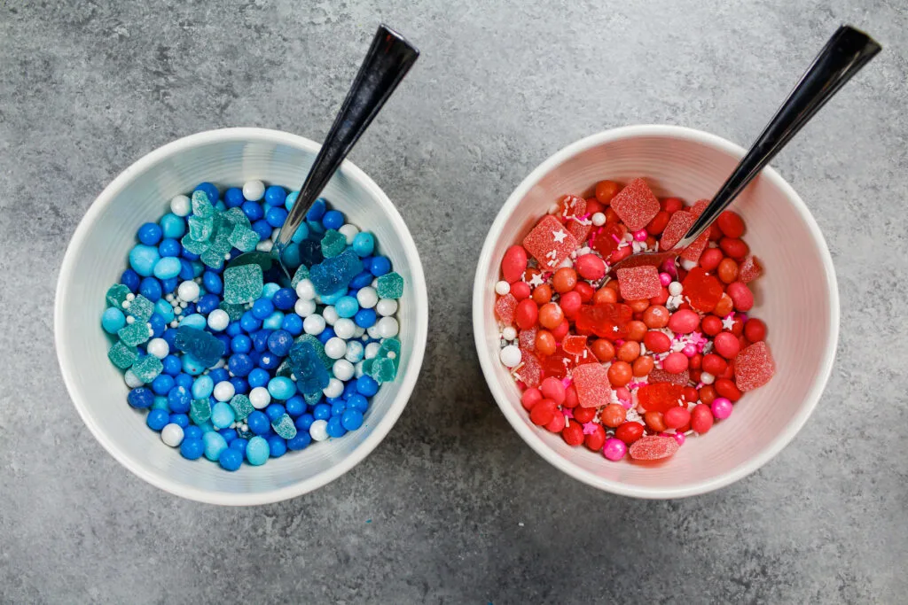 image of pink and blue candy and sprinkles ready to be used to fill a surprise inside cake for an exciting gender reveal party