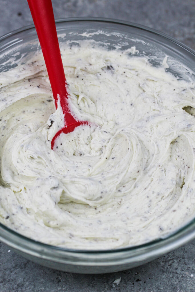 image of oreo cream cheese buttercream frosting made in a glass bowl