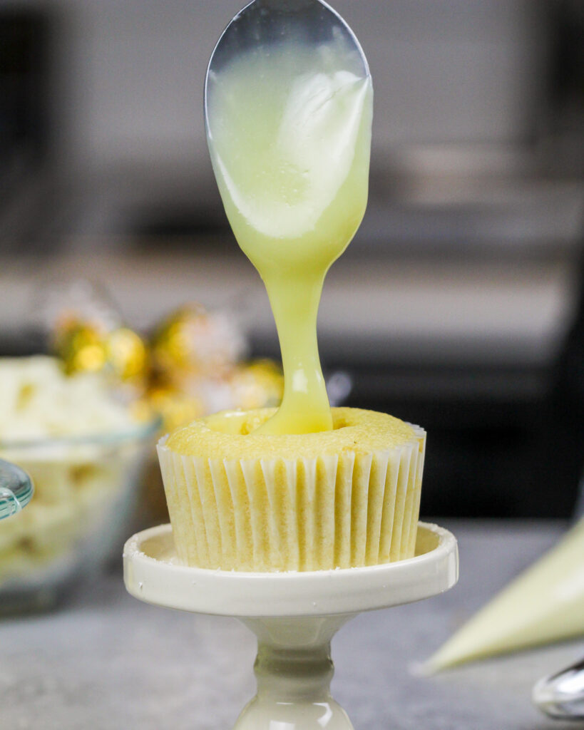 image of white chocolate cupcakes being filled with white chocolate ganache