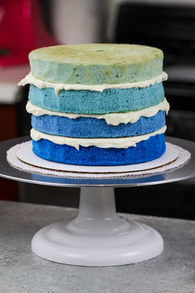 image of ombre blue cake layers stacked and frosted with american buttercream