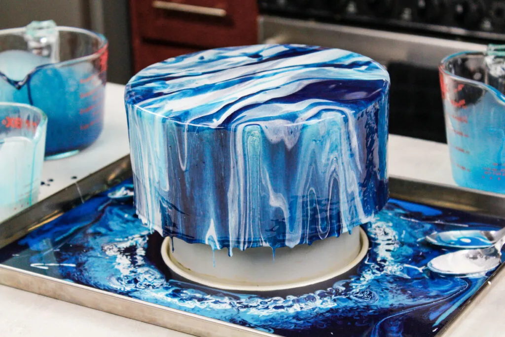 image of an ocean inspired white and blue mirror glaze cake