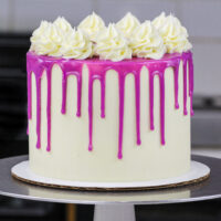 image of a purple drip cake made with a colorful white chocolate ganache