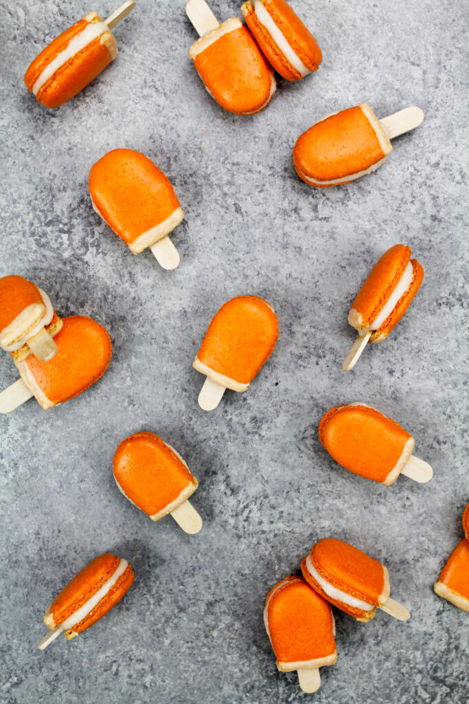 image of mini orange creamsicle macarons filled with orange creamsicle buttercream