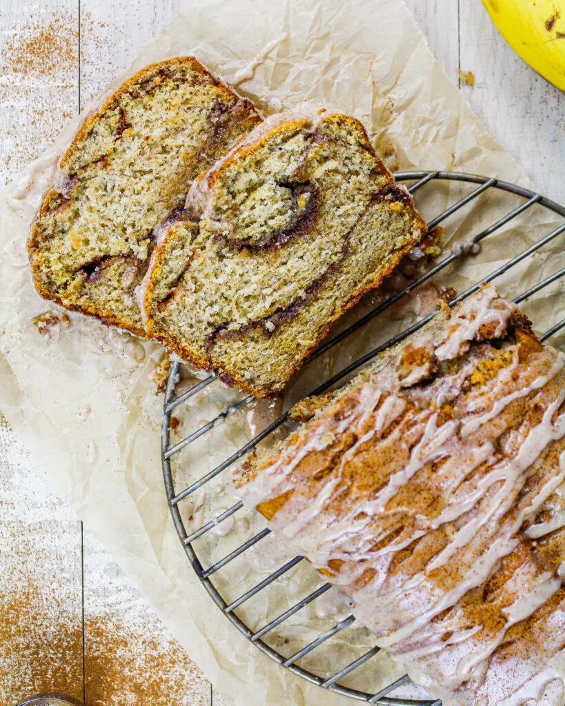 image of cinnamon swirl banana bread loaf that's been sliced into to show its beautiful cinnamon sugar swirls shared as part of a banana recipe round up