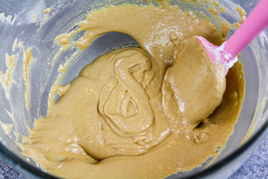 image of coffee macaron batter that has passed the figure 8 test and has been mixed to the right consistency