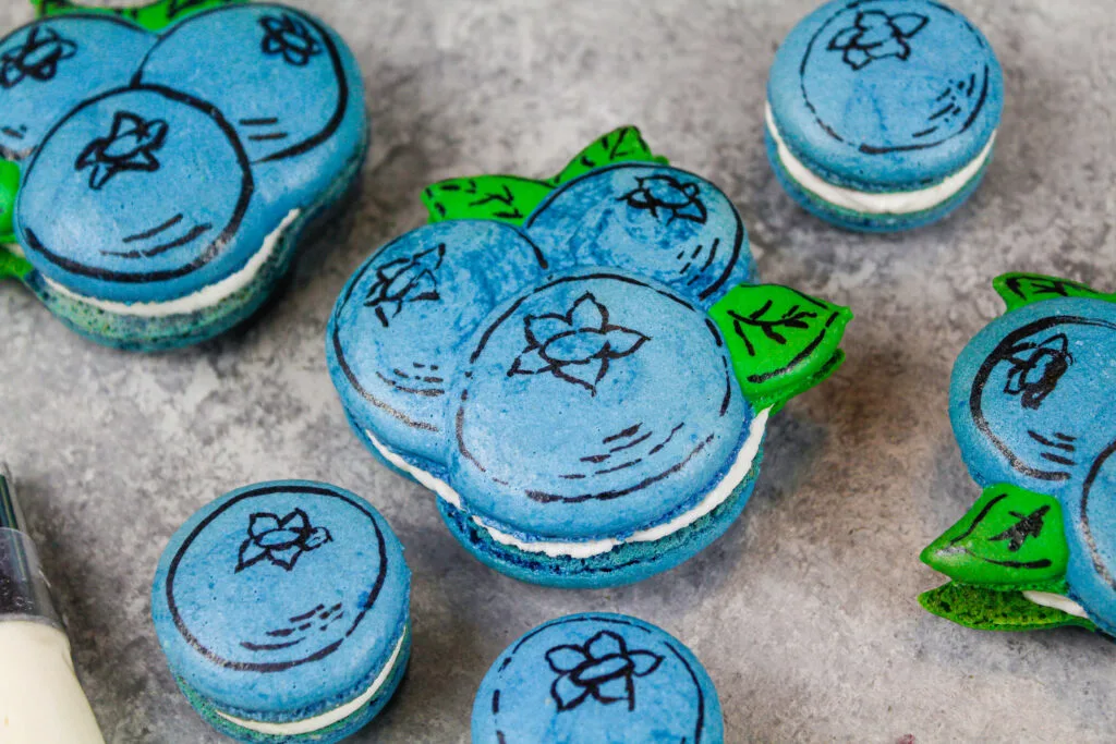 image of cute blueberry macarons that have been drawn on with edible marker