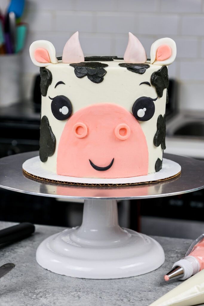 image of an adorable buttercream cow birthday cake made with marbled chocolate and vanilla cake layers